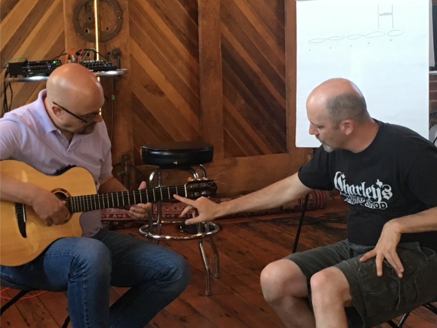 Adam Rafferty teaching a student one on one at a guitar retreat