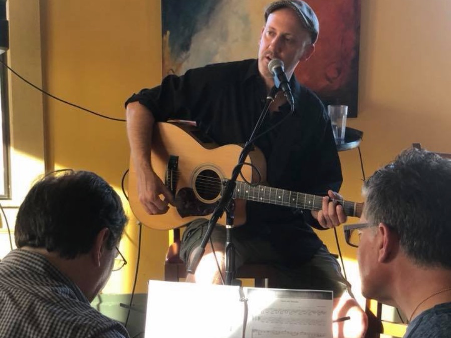 Adam Rafferty teaching a small groupd of guitarists